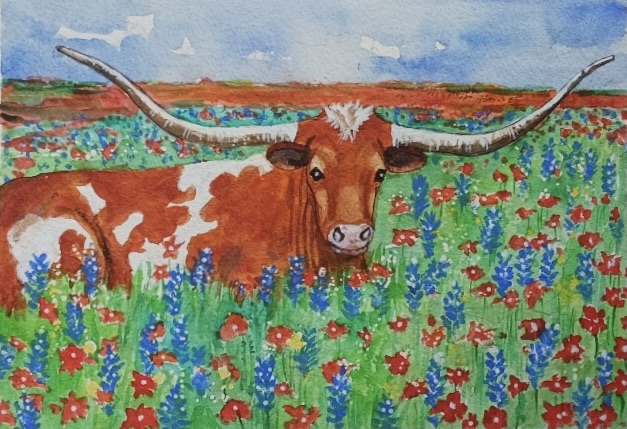 Longhorn in a field of bluebonnets and indian paintbrush